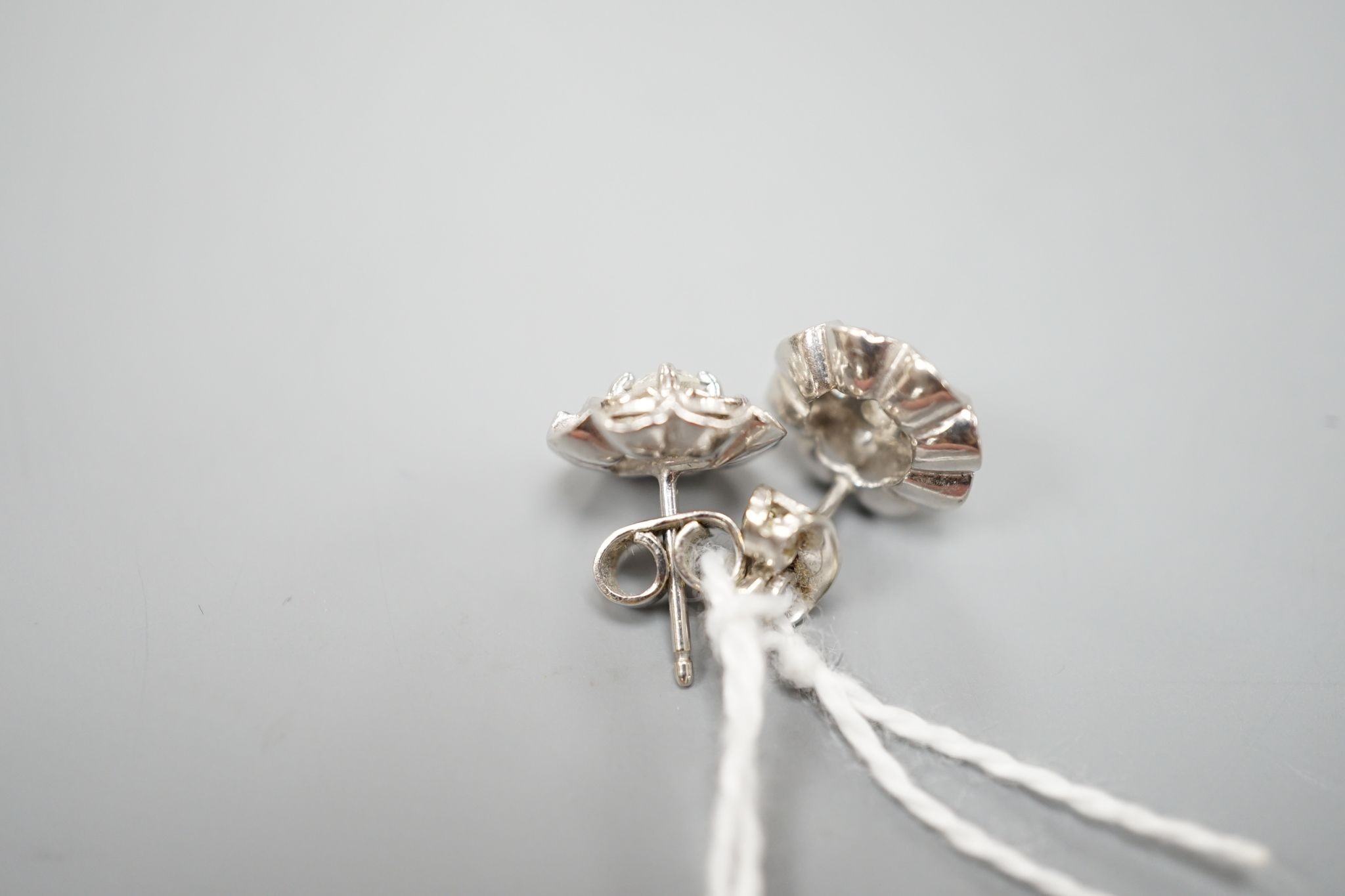 A pair of 750 white metal and five stone diamond cluster set earrings, 10mm, gross weight 3.2 grams.